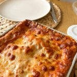 Delicious homemade Bolognese lasagna in a baking dish, fresh out of the oven.
